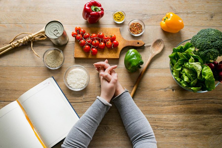 woman-leaning-on-table-with-various-ingredients-and-a-diet-planning-book appetite suppressant