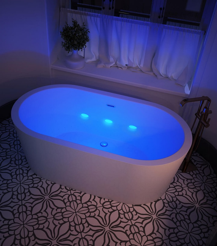 picture of a bathtub with lights for chromaterapy on tiles with black flowers