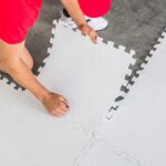 man putting hockey tiles on the floor